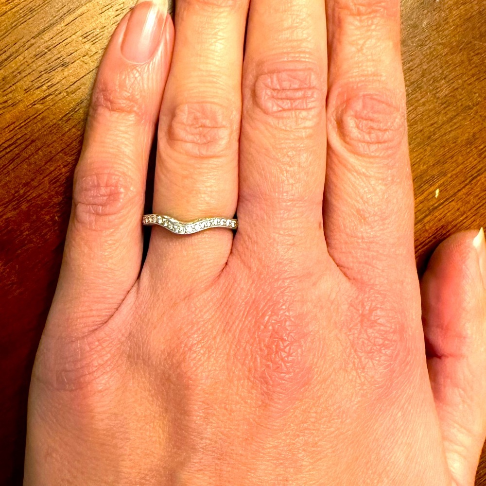 Wedding band. 14k yellow gold dipped in white gold. About 22 diamond chips.